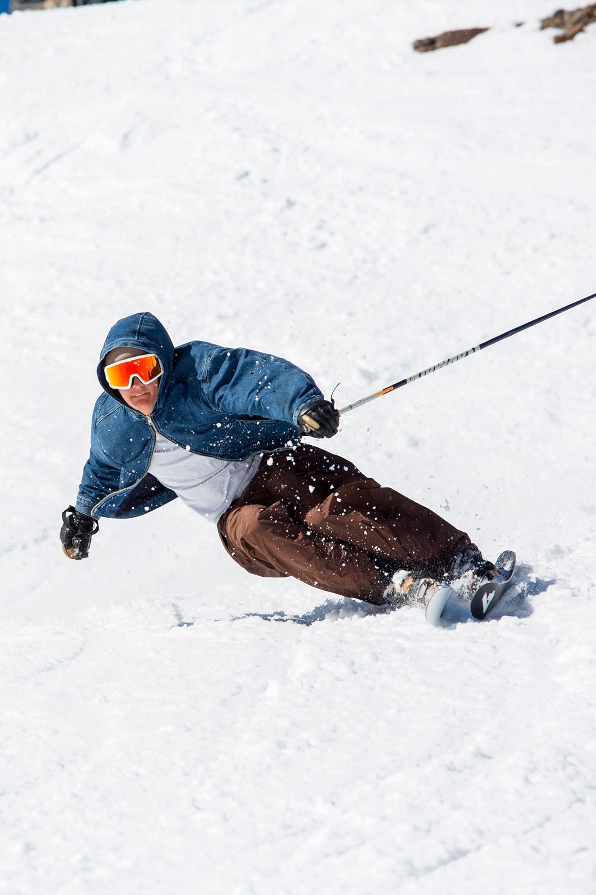 A skier carving a turn on a snowy slope